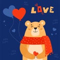 Satisfied little bear holds a heart ballons